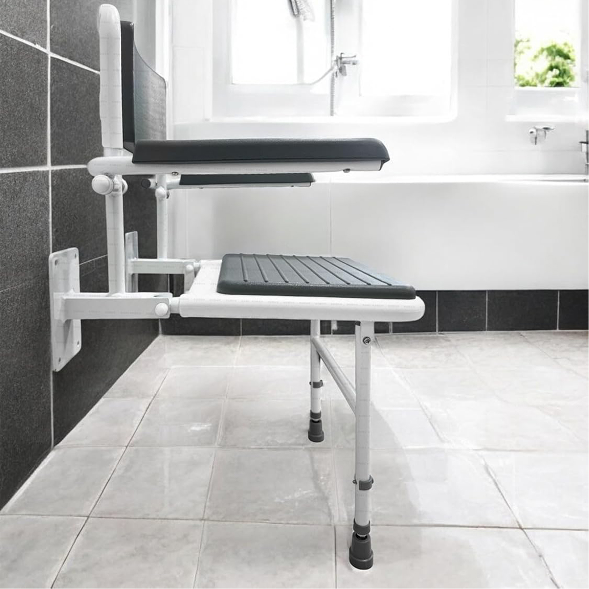 A profile view of the padded wall mounted shower seat in grey and white